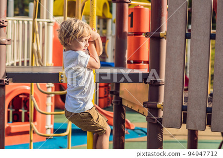 Funny cute happy baby playing on the playground. The emotion of happiness, fun, joy 94947712