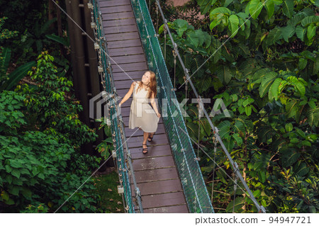 Young woman at the Suspension bridge in Kuala Lumpur, Malaysia 94947721