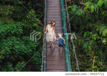 Mother and son at the Suspension bridge in Kuala Lumpur, Malaysia Mother and son at the Suspension bridge in Kuala Lumpur, Malaysia 94947722