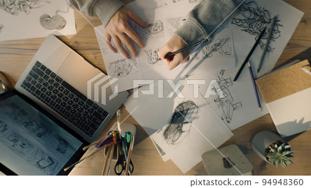Female artist draws pencil sketches on a paper illustration animation storyboard 94948360
