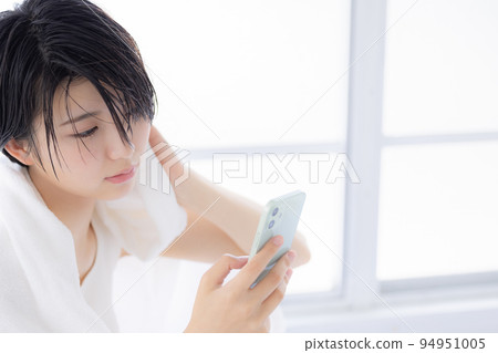 Beauty image A young woman looking at her smartphone Beauty image A young woman looking at her smartphone 94951005