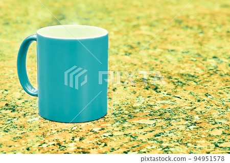Emerald ceramic cup mug on yellow green spotted background Emerald ceramic cup mug on yellow green spotted background 94951578