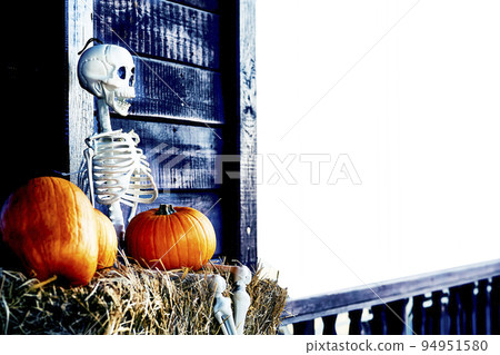 Halloween skeleton on hay surrounded by orange pumpkins. White space for text Halloween skeleton on hay surrounded by orange pumpkins. White space for text 94951580