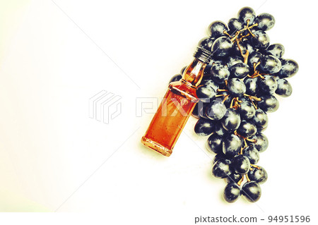 Good old brandy cognac and black ripe grapes and on white Good old brandy cognac and black ripe grapes and on white 94951596