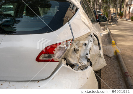 White car after the accident. Broken car on the street close-up. White car after the accident. Broken car on the street close-up. 94951921