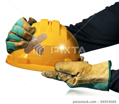Gloved Hands Holding an Orange Safety Helmet with Cross Band Aid Gloved Hands Holding an Orange Safety Helmet with Cross Band Aid 94954089