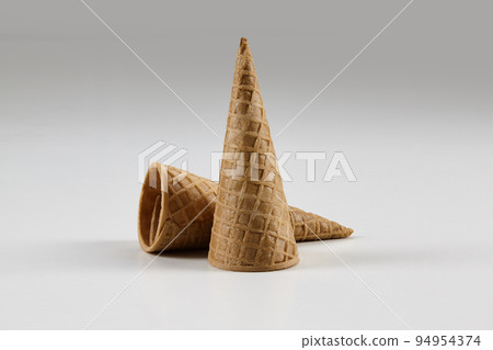 Two empty, medium wafer cones for ice cream isolated on white. Concept of food, treats. Mockup, template for your advertising and design. Close up 94954374
