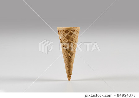 Empty small wafer cone for ice cream isolated on white. Concept of food, treats. Mockup, template for your advertising and design. Close up Empty small wafer cone for ice cream isolated on white. Concept of food, treats. Mockup, template for your advertising and design. Close up 94954375