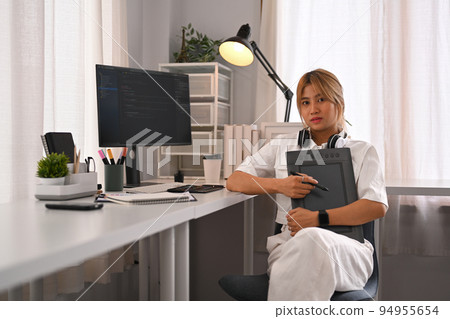 Young female programmer working with coded data on desktop computer in bright modern office Young female programmer working with coded data on desktop computer in bright modern office 94955654