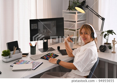 Young creative woman using graphic tablet and professional computer working for design project at home office Young creative woman using graphic tablet and professional computer working for design project at home office 94955655