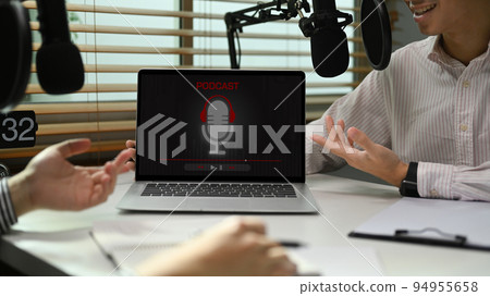 Image of radio host using microphone and laptop to recording podcast in home studio. Radio, podcasts and technology concept 94955658