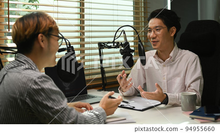 Image of radio host using microphone and laptop to recording podcast in home studio. Radio, podcasts and technology concept Image of radio host using microphone and laptop to recording podcast in home studio. Radio, podcasts and technology concept 94955660
