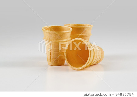 Three empty, toasty wafer cups for ice cream isolated on white. Concept of food, treats. Mockup, template for your advertising and design. Close up Three empty, toasty wafer cups for ice cream isolated on white. Concept of food, treats. Mockup, template for your advertising and design. Close up 94955794
