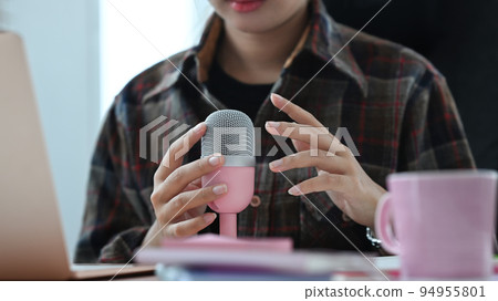 Image of radio host using microphone and laptop to recording podcast in home studio. Radio, podcasts and technology concept Image of radio host using microphone and laptop to recording podcast in home studio. Radio, podcasts and technology concept 94955801