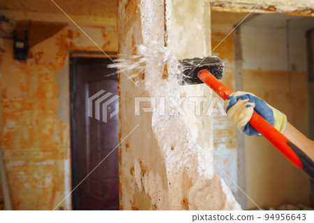 Young male builder in hard hat holding tools. Apartment repair and renovation concept. Young male builder in hard hat holding tools. Apartment repair and renovation concept. 94956643