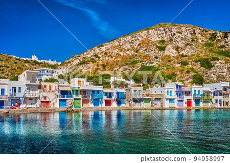 Colorful village of Klima with traditional Greek houses, Milos, Greece. Whitewashed houses with painted doorways and boat garages on sunny summer day. Colorful village of Klima with traditional Greek houses, Milos, Greece. Whitewashed houses with painted doorways and boat garages on sunny summer day. 94958997