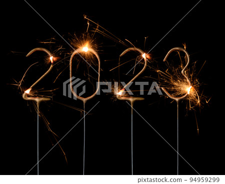 Happy New Year 2023 Silvester party card. Digits of year 2023 made by golden burning sparklers 94959299