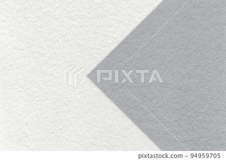 Texture of white paper background, half two colors with gray arrow, macro. Structure of craft grey cardboard. 94959705
