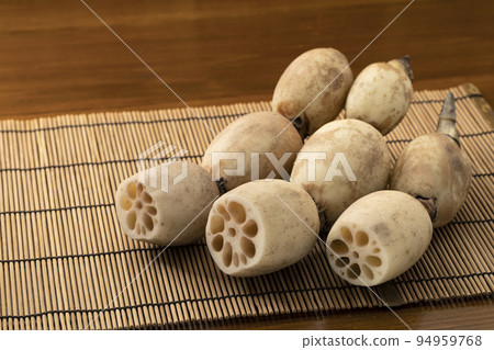 Lotus root placed on a bamboo place mat 94959768