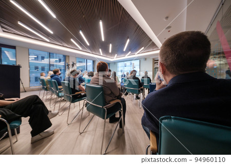 Businesspeople watching presentation in evening 94960110