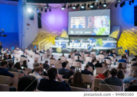 Businesspeople watching online conference in auditorium Businesspeople watching online conference in auditorium 94960160