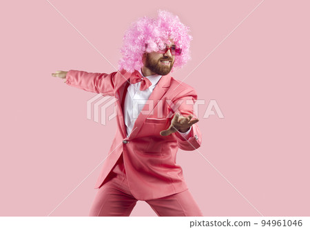 Funny bearded man in wig, glasses and suit having fun isolated on pink background. Funny bearded man in wig, glasses and suit having fun isolated on pink background. 94961046