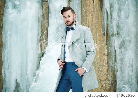Outdoor portrait of handsome man in gray coat Outdoor portrait of handsome man in gray coat 94962650