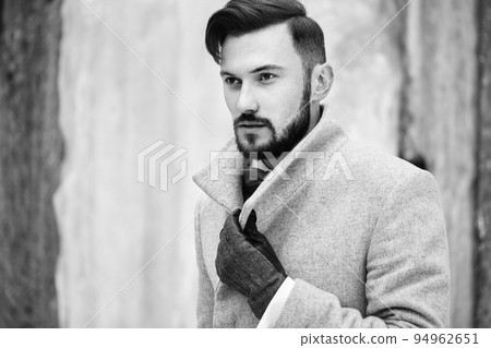 Outdoor portrait of handsome man in gray coat 94962651