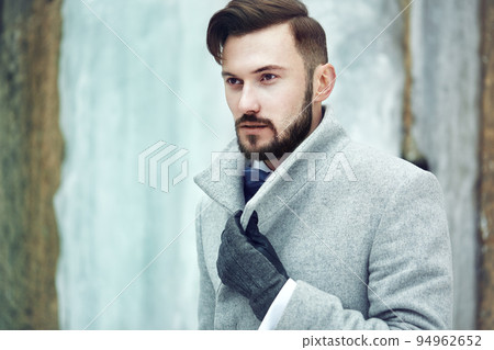 Outdoor portrait of handsome man in gray coat 94962652