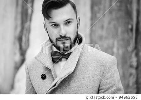 Outdoor portrait of handsome man in gray coat Outdoor portrait of handsome man in gray coat 94962653