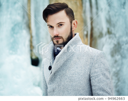 Outdoor portrait of handsome man in gray coat 94962663