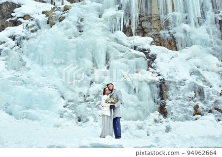 Happy couple hugging on rock on the background of nature 94962664