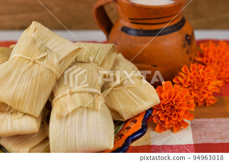 Mexican cuisine tamales, atole, and marigolds inspired by the Day of the Dead Mexican cuisine tamales, atole, and marigolds inspired by the Day of the Dead 94963018