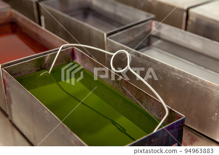 Scientist staining microscope slides for cytology studies in the laboratory. Scientist staining microscope slides for cytology studies in the laboratory. 94963883