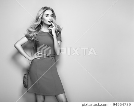 Blonde young woman in elegant summer dress Blonde young woman in elegant summer dress 94964789