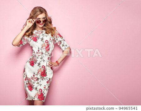 Blonde young woman in floral spring summer dress Blonde young woman in floral spring summer dress 94965541