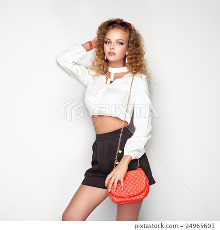 Blonde woman in summer blouse and shorts 94965601