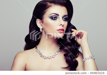 Brunette woman with long shiny wavy hair Brunette woman with long shiny wavy hair 94965828