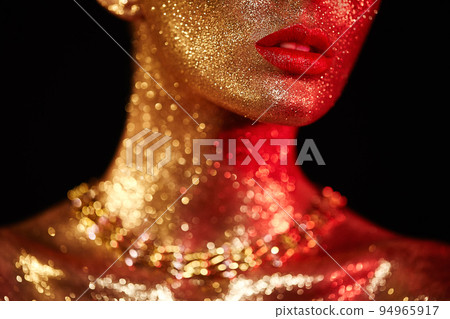Portrait of beautiful woman with sparkles on her face 94965917