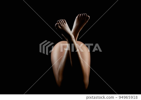 female beautiful Naked legs. girl body silhouette in the dark 94965918