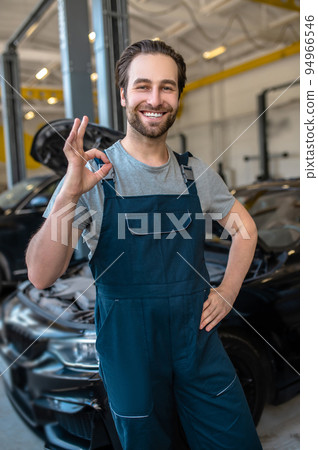Car repair worker posing for the camera in the workplace 94966546