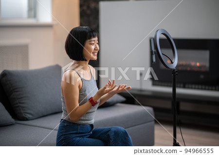 Cheerful vlogger live-streaming from her cell phone 94966555