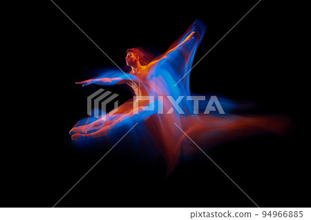 Aspiration. Solo performance of flexible male ballet dancer dancing isolated on dark background in glowing colorful neon light. Grace, art, beauty Aspiration. Solo performance of flexible male ballet dancer dancing isolated on dark background in glowing colorful neon light. Grace, art, beauty 94966885