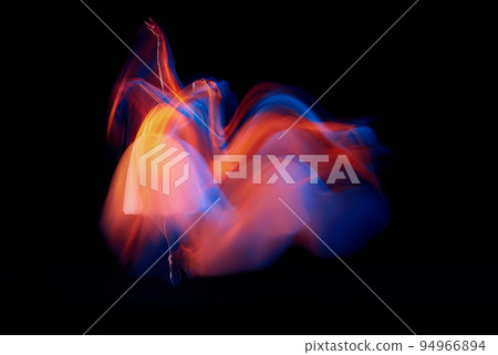 Futurism, fantasy, miracle. Graceful and fragile ballerina in ballet dress in motion isolated over black background in mixed neon light. 94966894