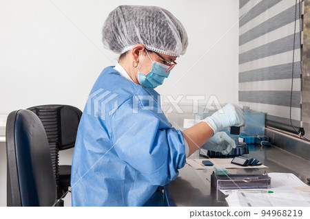Laboratorian giving admission to pap smear samples in the laboratory for analysis. Scientist receiving patient samples for laboratory for analysis. Cervical cancer concept. Medical concept. Laboratorian giving admission to pap smear samples in the laboratory for analysis. Scientist receiving patient samples for laboratory for analysis. Cervical cancer concept. Medical concept. 94968219
