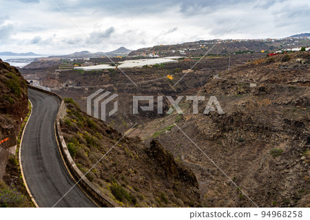 Classic Gran Canaria landscape with a road and a banana plantation Classic Gran Canaria landscape with a road and a banana plantation 94968258