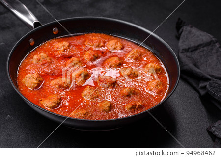 Delicious meatballs made from ground beef in a spicy tomato sauce Delicious meatballs made from ground beef in a spicy tomato sauce 94968462