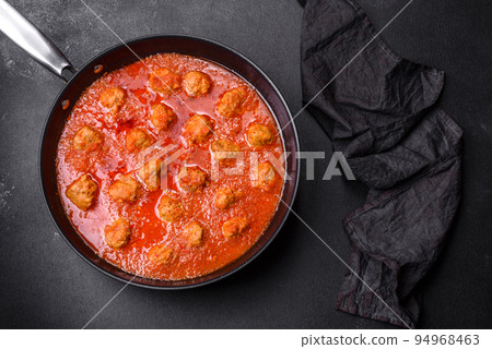 Delicious meatballs made from ground beef in a spicy tomato sauce Delicious meatballs made from ground beef in a spicy tomato sauce 94968463