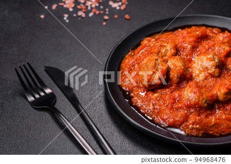 Delicious meatballs made from ground beef in a spicy tomato sauce Delicious meatballs made from ground beef in a spicy tomato sauce 94968476