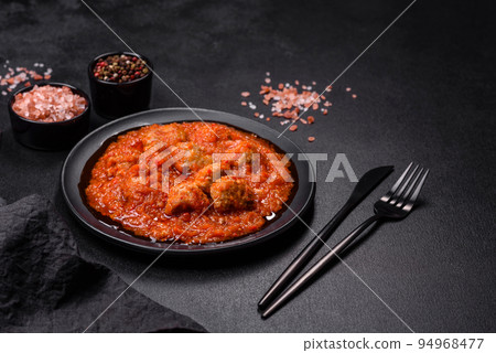 Delicious meatballs made from ground beef in a spicy tomato sauce Delicious meatballs made from ground beef in a spicy tomato sauce 94968477